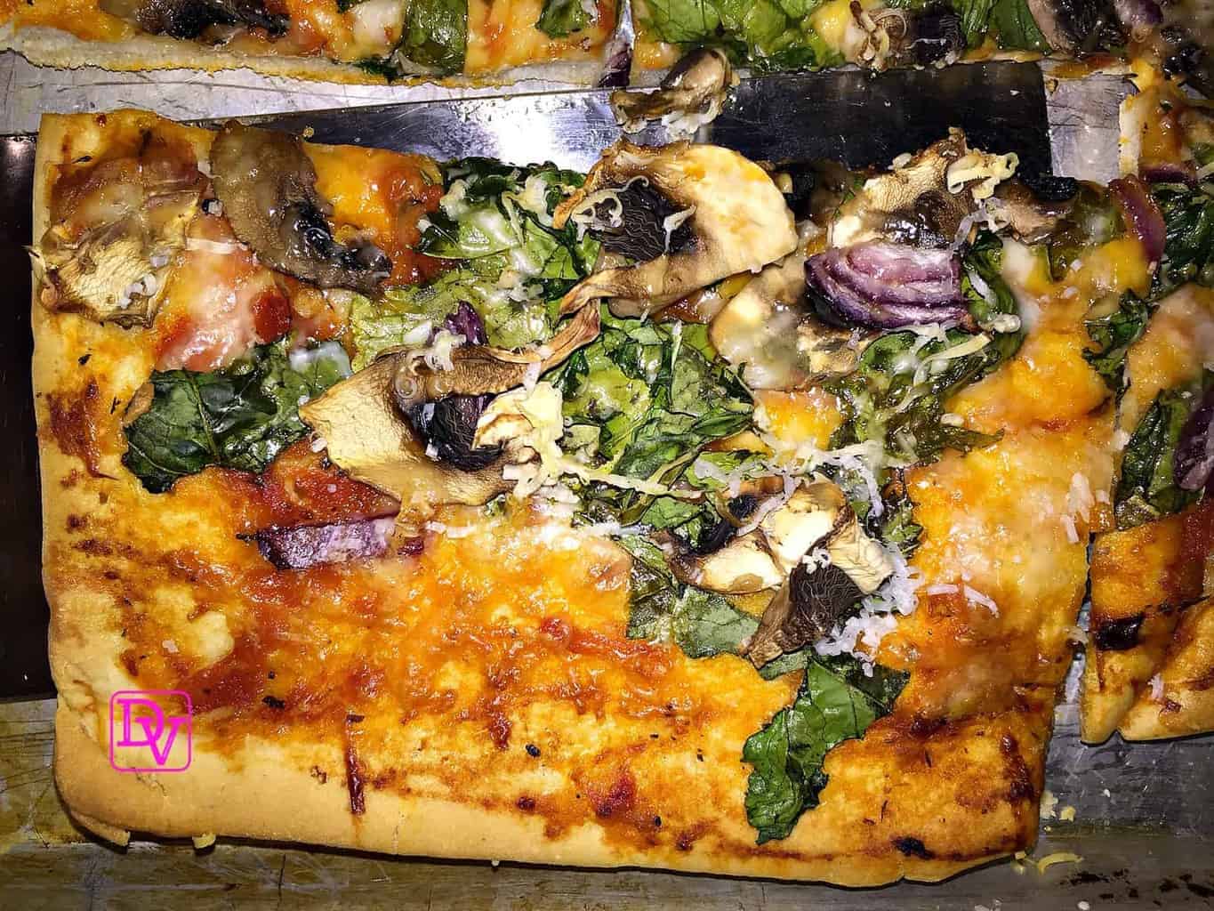 Veggie Pizza With Dandelion Greens 4 dandelion pizza, dandelion, greens, onions, red onions, mushrooms, sliced mushrooms, colander, gourmet, gourmet pizza, gourmet pizza at home, meatless pizza, vegetarian pizza, veggie pizza, shell, cheese, romano cheese, fresh grated cheese, food, food blogger, dana vento, dandelion green pizza, veggie pizza with dandelion greens, recipe, recipes, foodies, easy to make