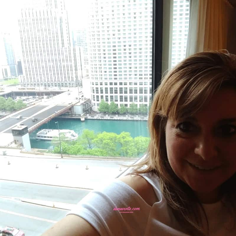 dana in window shot of Downtown Chicago view in the Swissotel