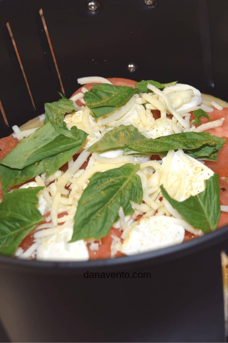 air fryer Margherita pizza in the the air fryer basket 