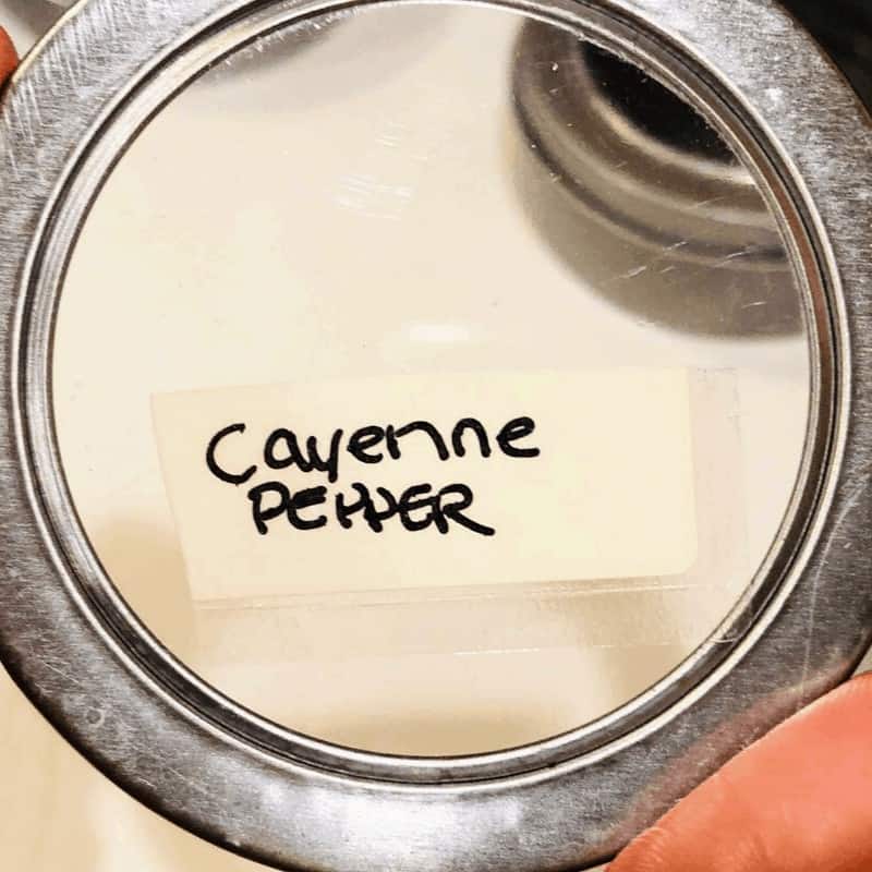 a label marked cayenne pepper on a magnetic spice container