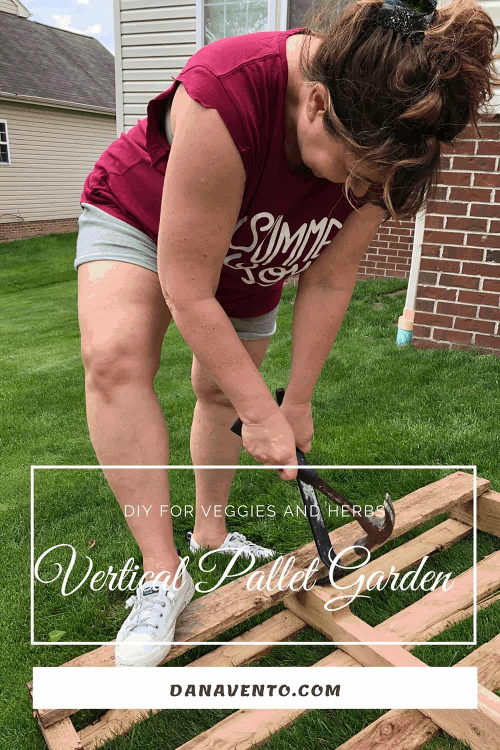 Dana Vento Yanking the nails out of a pallet for a pallet DIY 