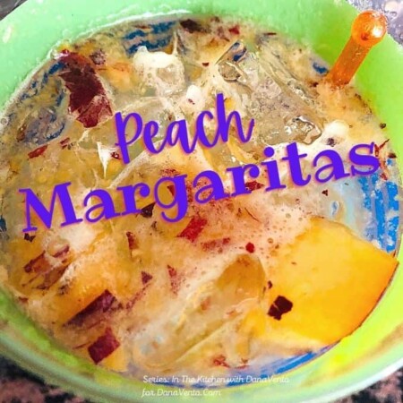 peach margaritas one in glass with floating peach pieces
