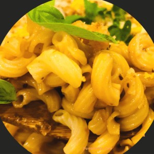 Herb and Elbow Pasta on a Wooden Spoon