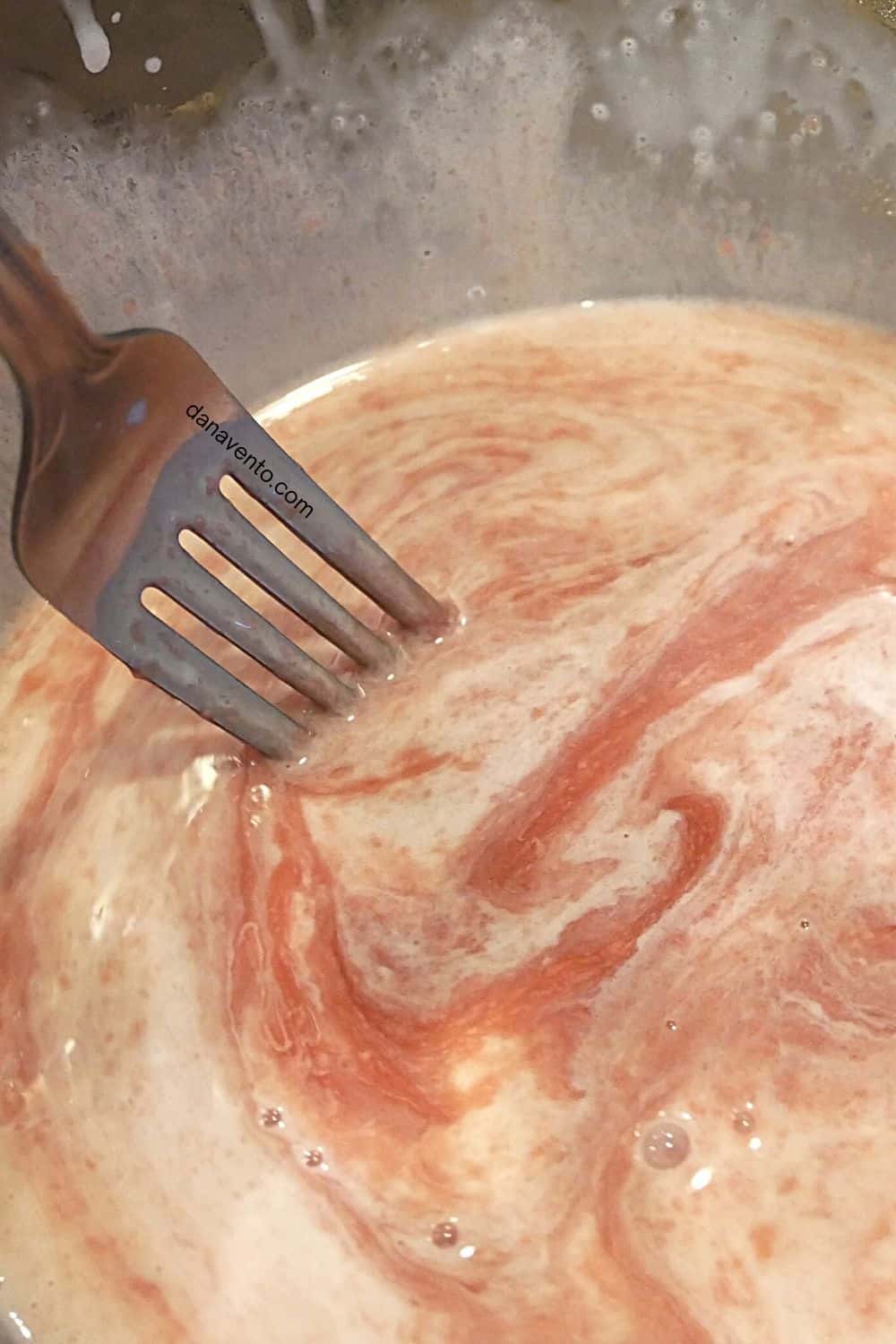 mixing candy wafers with cream for red ganache