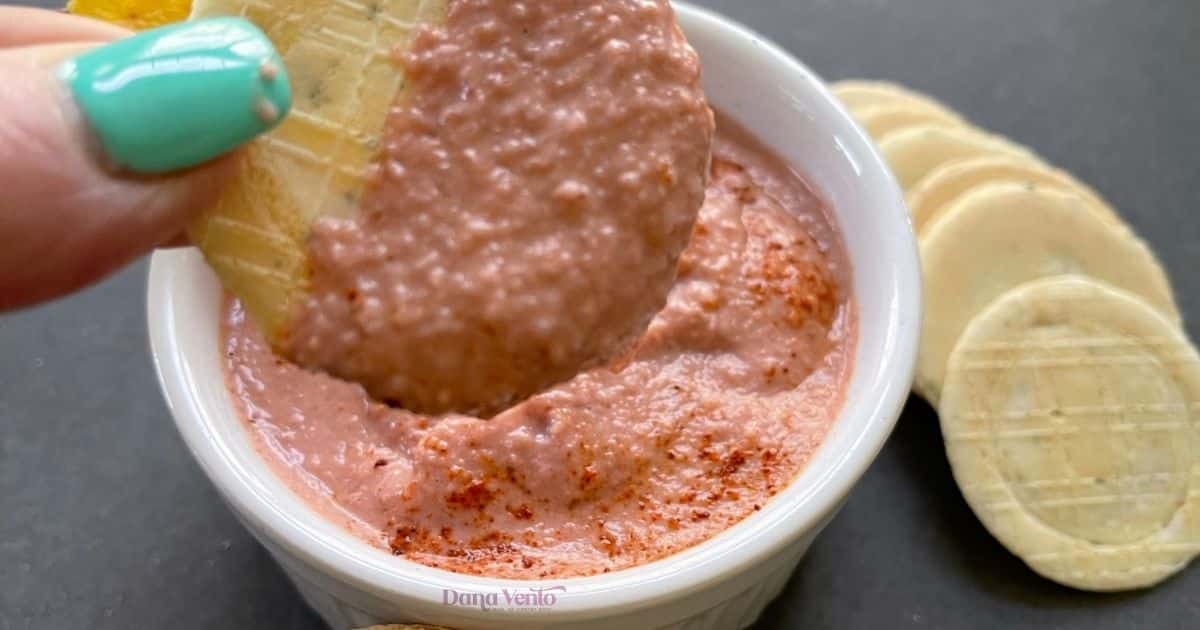 close up of hummus that is pink from beets in bowl