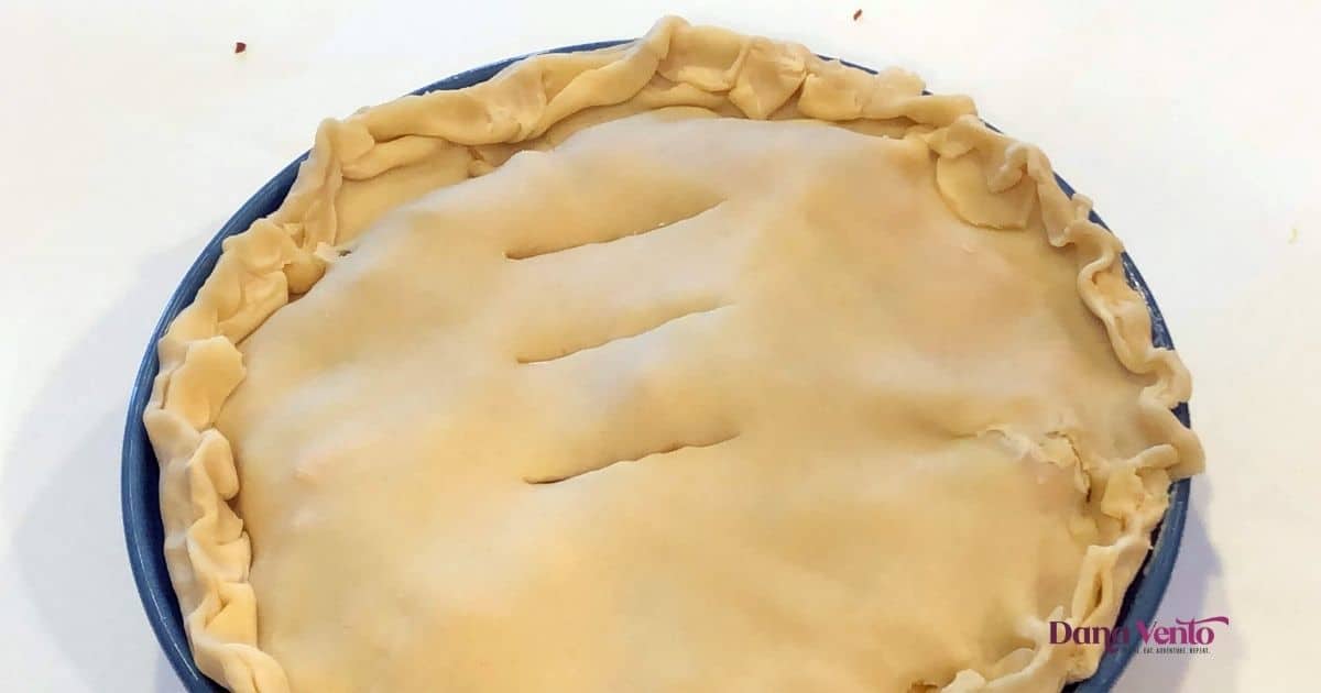 top crust crimped and slit on ham meat pie