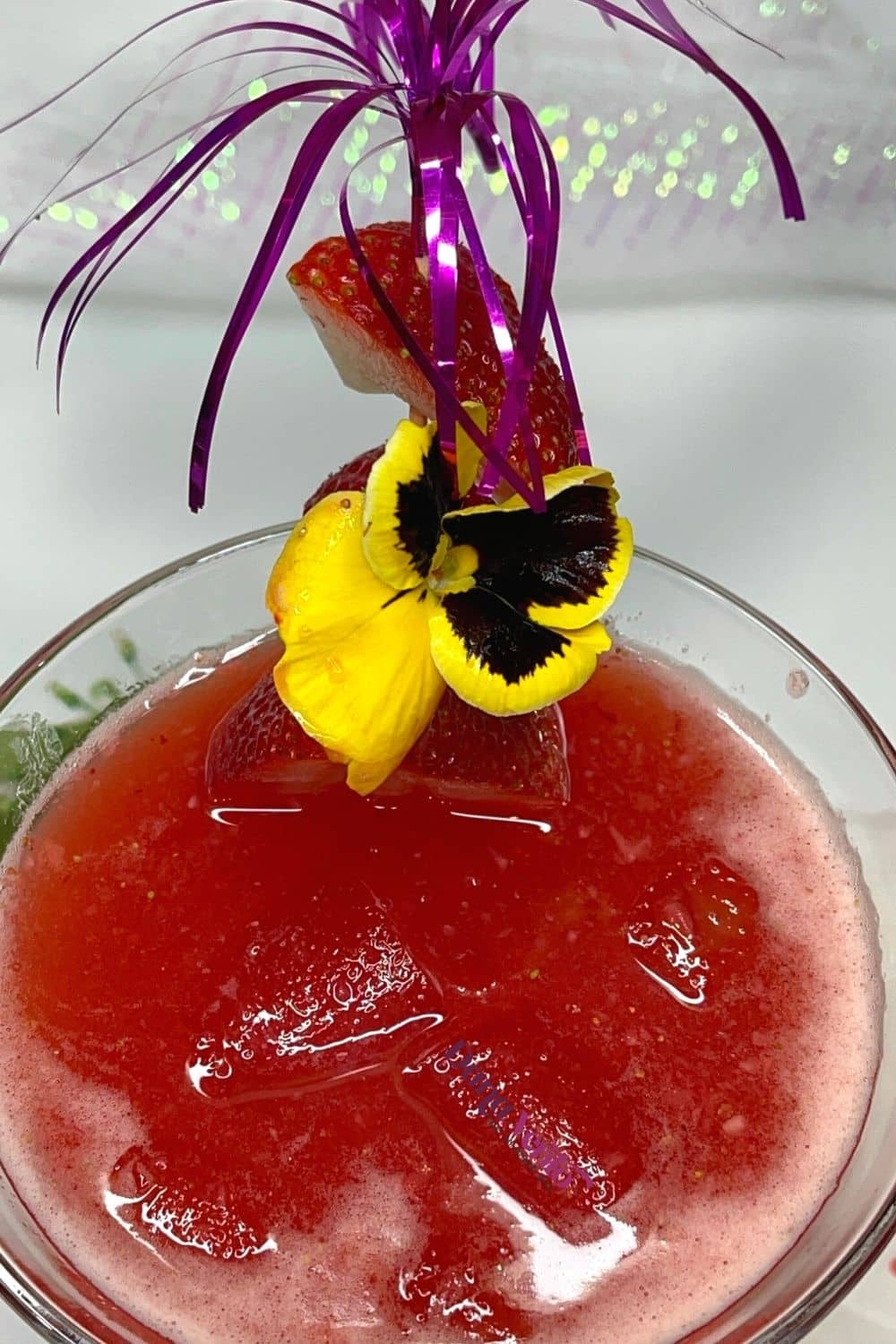 prepared and poured martini with strawberries in a martini glass