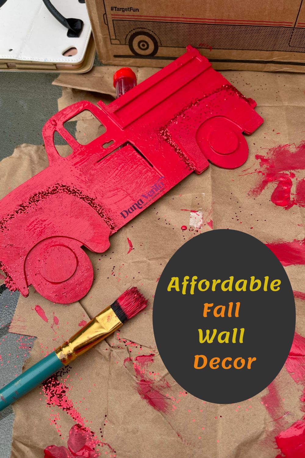 Red truck being painted for reversible DIY Fall Wall Decor
