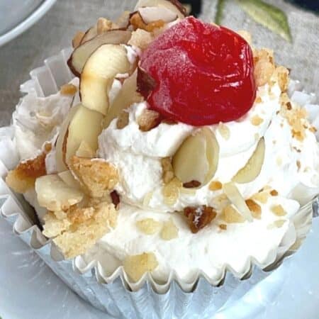 Easy Italian Almond Tortoni Dessert on a plate with a cherry on top and almond slices