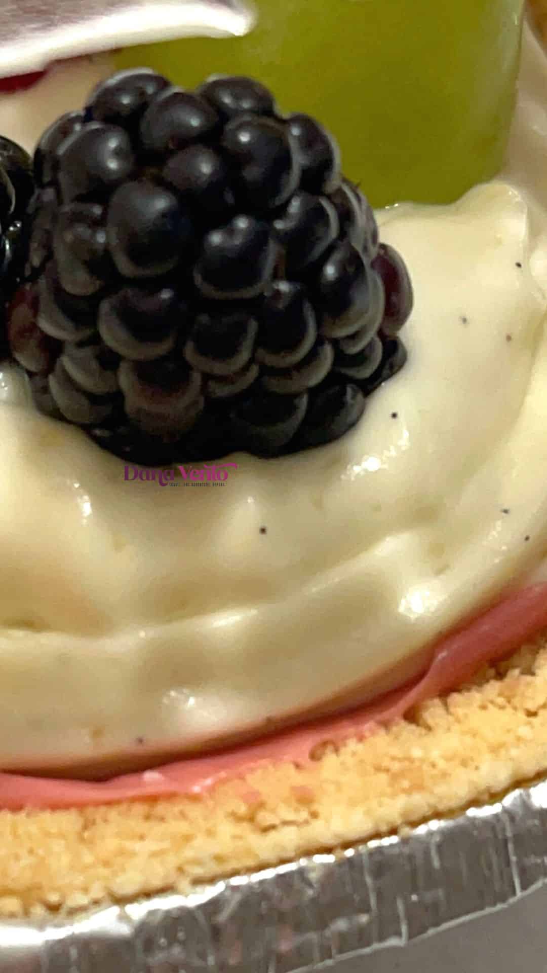 dazzling snow globe cream fruit tarts with vanilla bean paste in the cream filling and blackberries 