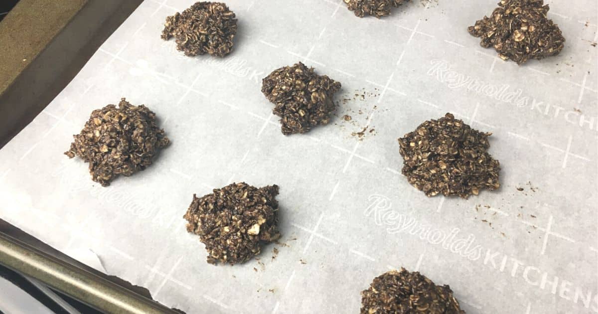 Easy Pantry Cleanout Chocolate Oatmeal Cookies on a baking tray and parchment paper 