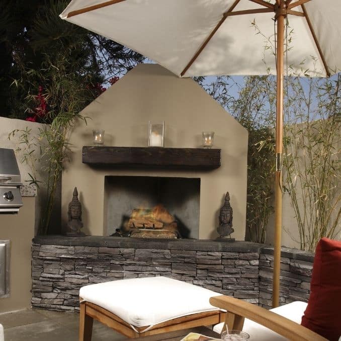 Create A Backyard Summer Oasis adding a fire pit or fire place and umbrella