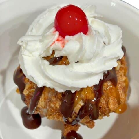 Air-Fried Mexican Fried Ice Cream striped with chocolate and caramel in a bowl