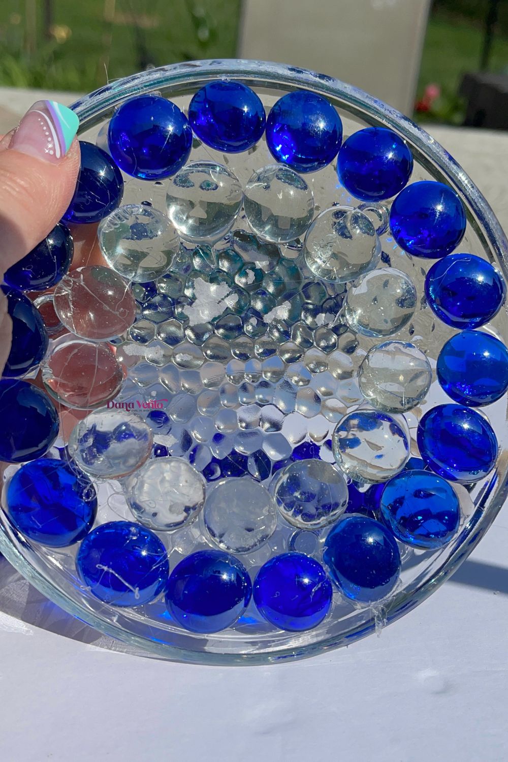 Colorful glass gems navy and white on Candle Rimmed Plate in process of making DIY Evil Eye Amulets