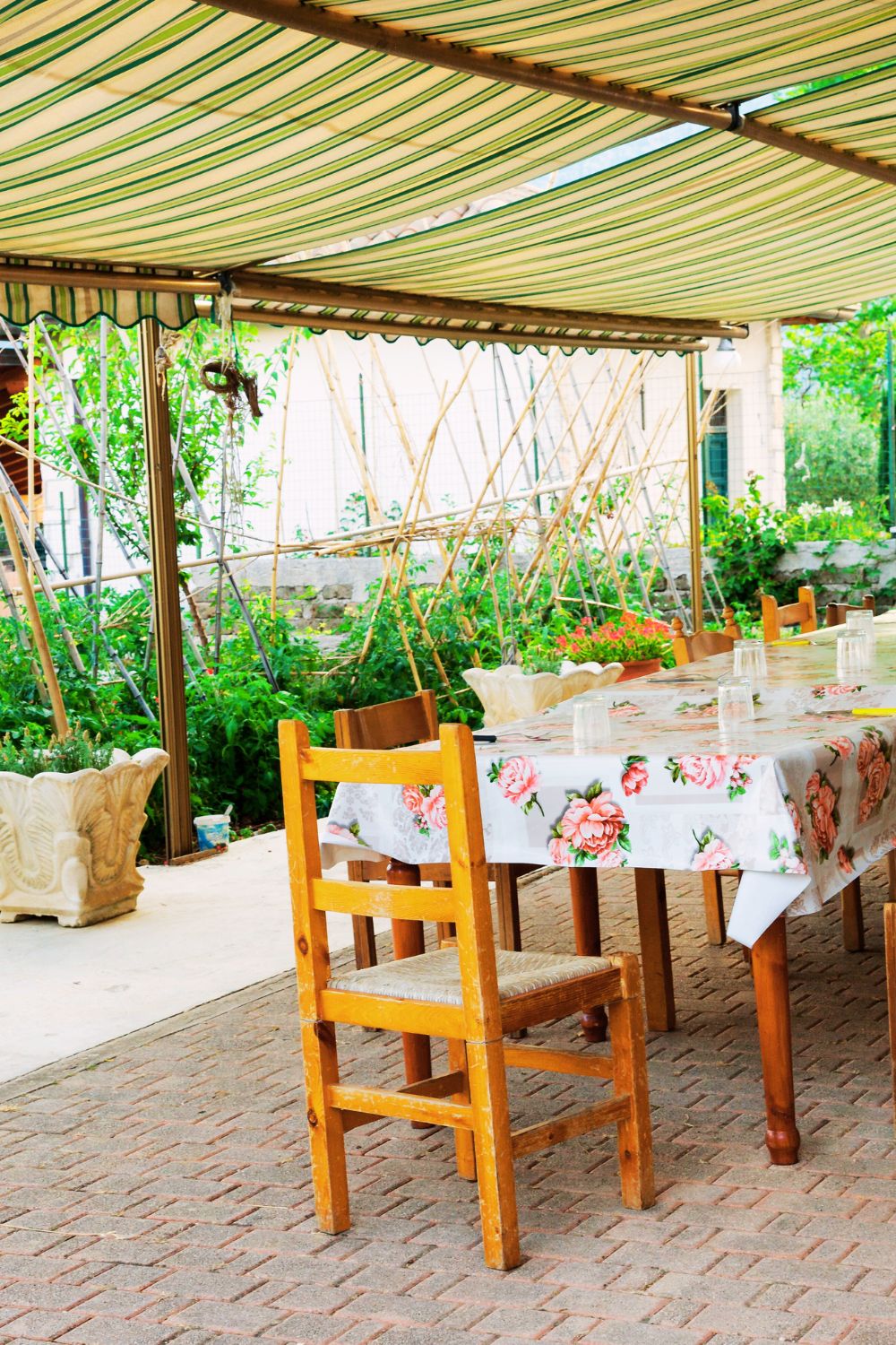 Italian courtyard set up with a pergola and a dining table in Italy