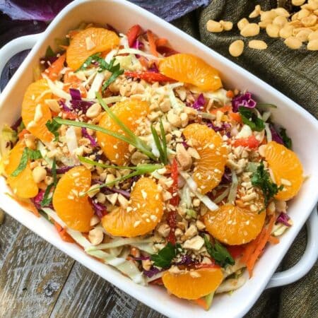 Asian Cabbage Salad with Warm Spicy Peanut Dressing in a bowl
