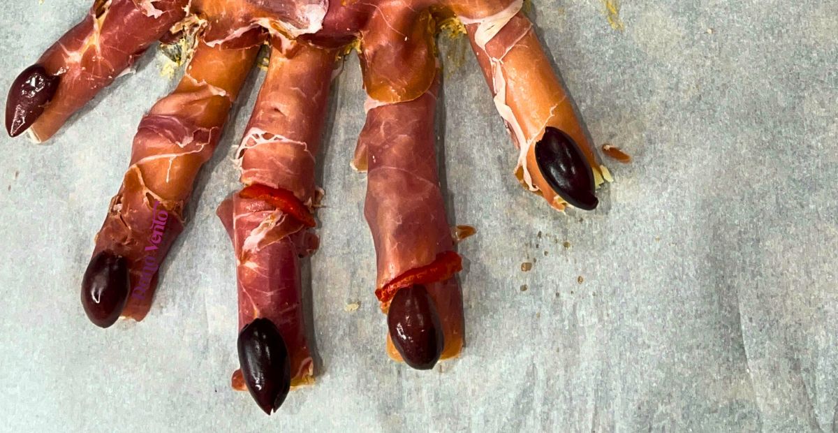 edible amputated hand appetizer fingertips with Kalamata olives